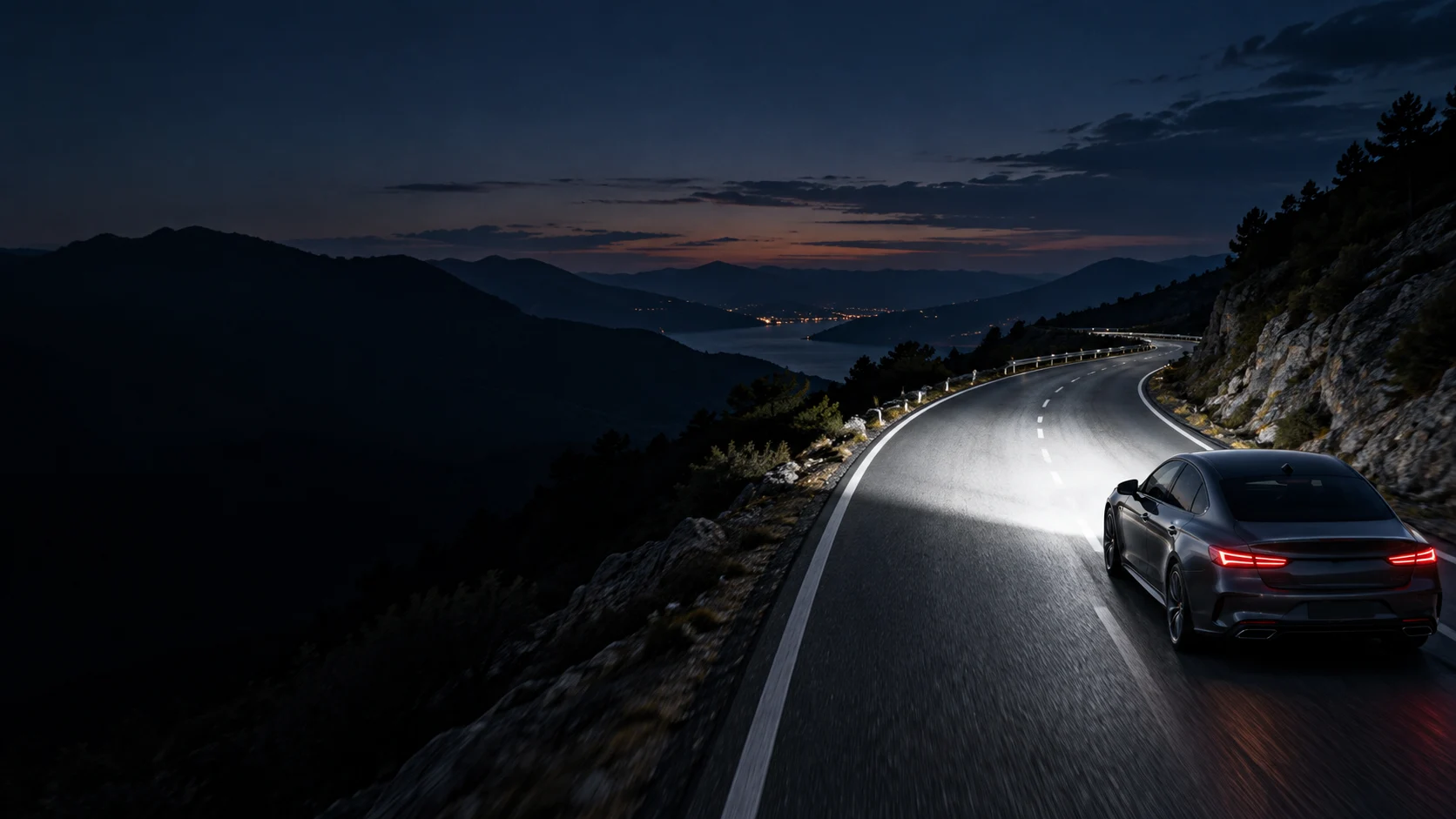 Conceptual night-driving scene with a car illuminating the road ahead